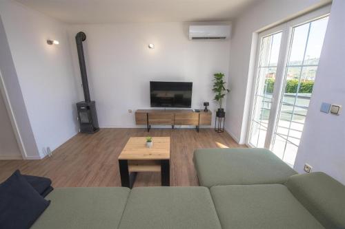 a living room with a couch and a tv at House Matilda in Primošten