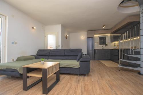 a living room with a couch and a table at House Matilda in Primošten