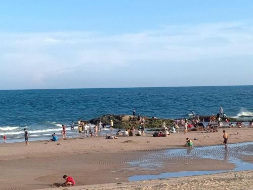 a group of people on a beach near the ocean at Hoàng Nga 2 Homestay in Phan Thiet