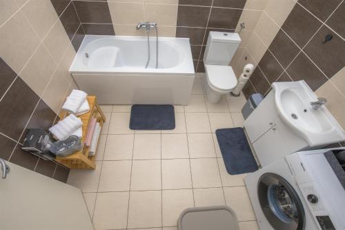 a bathroom with a tub and a toilet and a sink at House Matilda in Primošten