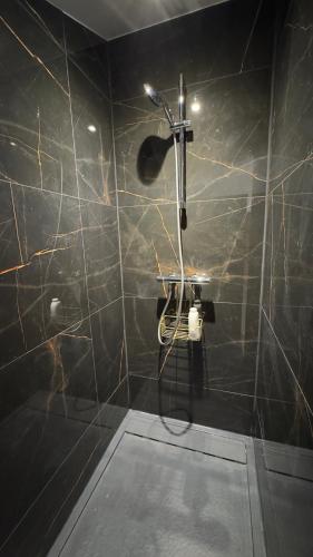 a bathroom with a shower with a shower head at La ferme Le Clos de la Becque in Muncq-Nieurlet