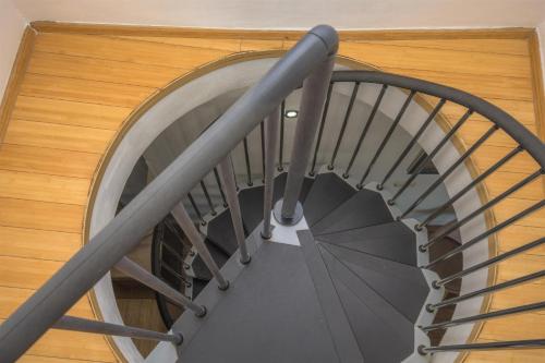 a spiral staircase in a building with a metal railing at House Matilda in Primošten