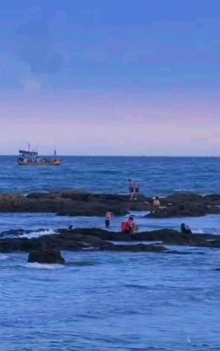 a group of people on rocks in the ocean at Hoàng Nga 2 Homestay in Phan Thiet