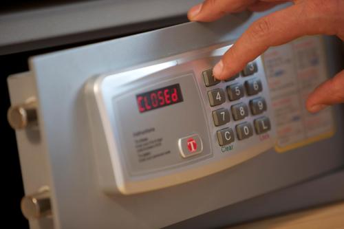 a person is pointing at a clock on an oven at Hotel Steinerwirt1493 in Zell am See