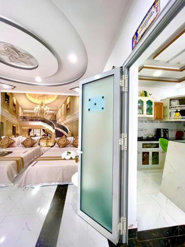 a room with a bed and a large glass door at Hoàng Nga 2 Homestay in Phan Thiet