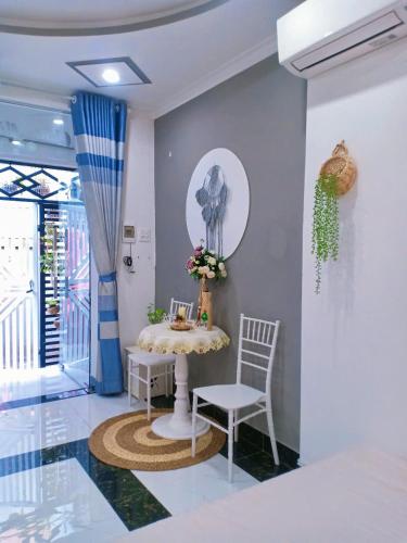 a dining room with a table and two chairs at Hoàng Nga 2 Homestay in Phan Thiet