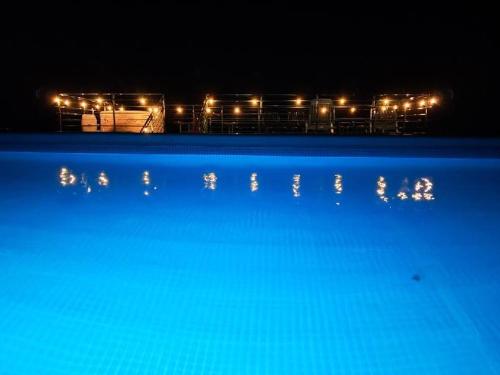 a view of a swimming pool at night with lights at Noclegi u Banysia w sercu Gór Świętokrzyskich in Krajno Pierwsze