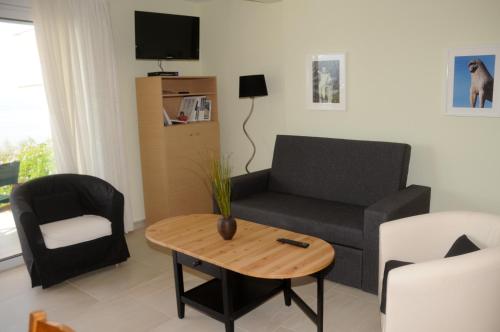 a living room with a couch and a table at Aegean View Villa in Loutraki