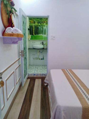 a bedroom with a bed and a bathroom with a sink at Hoàng Nga 2 Homestay in Phan Thiet