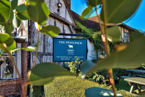 a sign for the woolpack inn in front of a building at The Woolpack Inn in Coggeshall