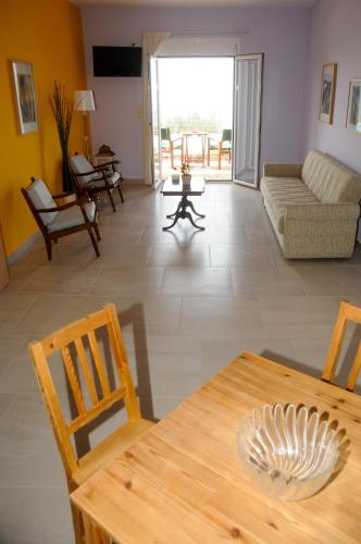 a living room with a table and chairs and a couch at Aegean View Villa in Loutraki