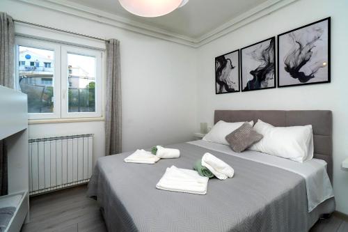 Un dormitorio con dos camas con toallas encima. en House Villa LuNi, en Brodarica