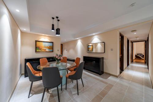 a living room with a table and chairs and a fireplace at Sherwood Residence in Ho Chi Minh City