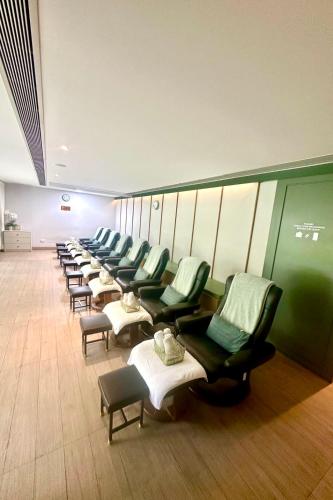 a row of chairs and tables in a waiting room at The Quarter Chaophraya by UHG in Bangkok