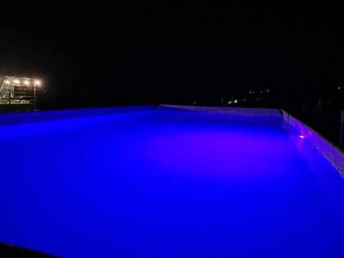 a swimming pool at night with blue illumination at Noclegi u Banysia w sercu Gór Świętokrzyskich in Krajno Pierwsze