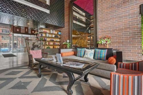 a living room with a couch and a coffee table at CozySuites Mill District with pool gym #12 in Minneapolis