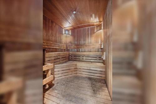 an empty sauna with wooden walls and a wooden floor at CozySuites Mill District with pool gym #12 in Minneapolis