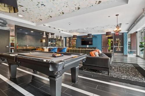 a billiard room with a pool table and a couch at CozySuites Mill District with pool gym #12 in Minneapolis