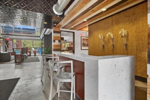 a lobby with a counter and stools in a building at CozySuites Mill District with pool gym #12 in Minneapolis
