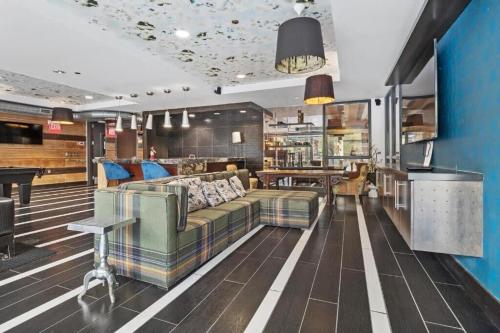 a living room with a couch and a bar at CozySuites Mill District with pool gym #12 in Minneapolis