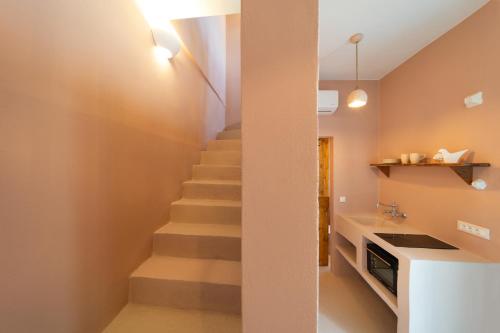a staircase in a kitchen with a stair case at Via Vasileia in Kattavía