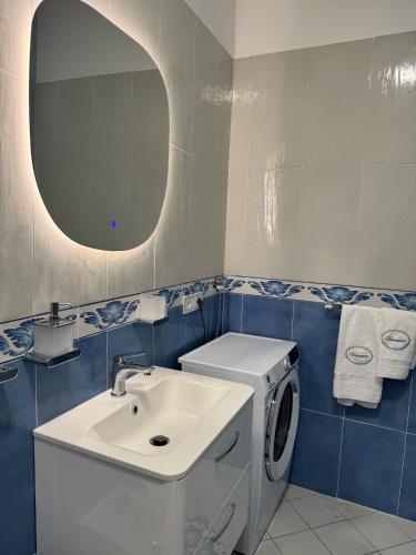 a bathroom with a washing machine and a sink at Vincanto Maiori Costiera Amalfitana in Maiori