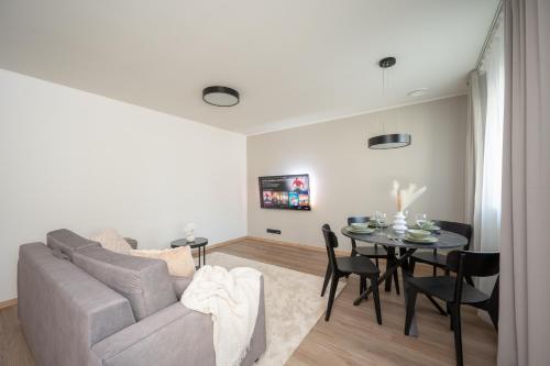 a living room with a couch and a table at Pärnu Pearl Residences in Pärnu