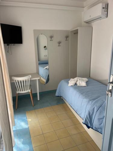 a bedroom with a bed and a table and a mirror at Vincanto Maiori Costiera Amalfitana in Maiori