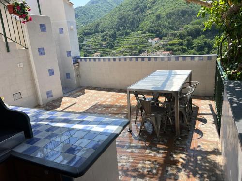 a table and chairs on a balcony with a view at Vincanto Maiori Costiera Amalfitana in Maiori