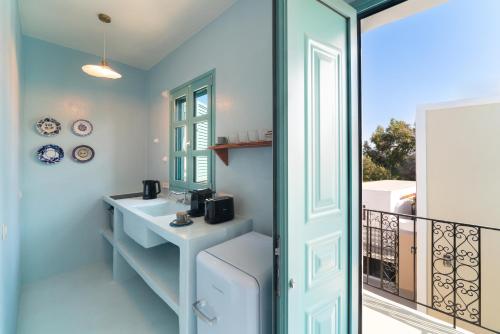 a bathroom with a sink and a balcony at Via Vasileia in Kattavía