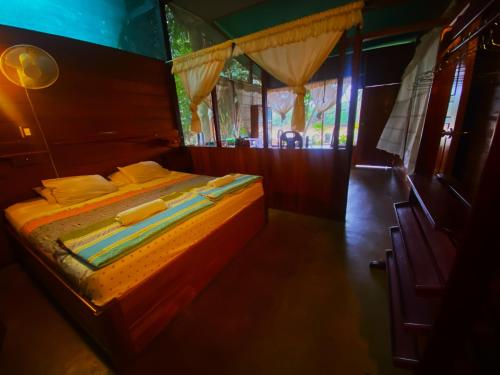 a bedroom with a bed in a train car at Coco house tambopata in Puerto Maldonado