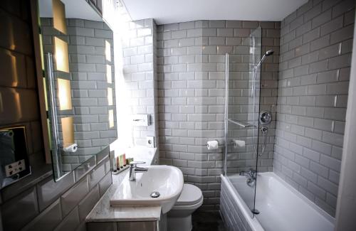 a bathroom with a sink and a toilet and a shower at Bowburn Hall Hotel in Durham