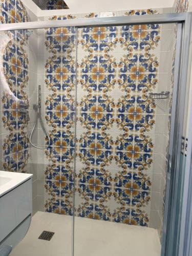 a bathroom with a shower with a blue and white tiles at Vincanto Maiori Costiera Amalfitana in Maiori