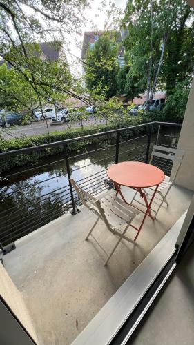 a table and two chairs sitting on a balcony with a table at Chez Max - Terrasse - Climatisation - Parking gratuit in Beaune