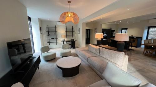 a living room with a couch and chairs and a table at Chez Max - Terrasse - Climatisation - Parking gratuit in Beaune