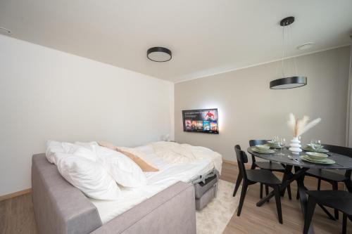 a living room with a couch and a table at Pärnu Pearl Residences in Pärnu