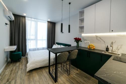 a kitchen with a table and a bed in a room at VS Apartments in Kyiv