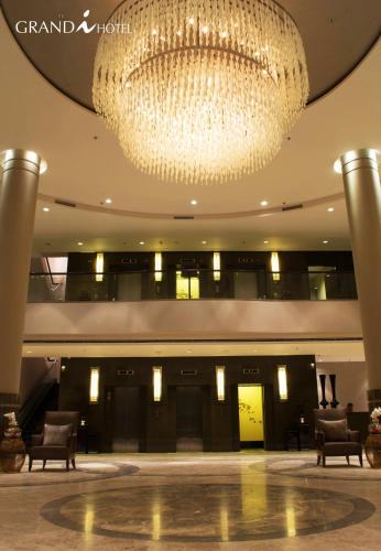 a large chandelier in the lobby of a hotel at I Hotel Batam in Nagoya