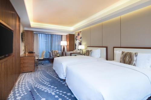 Ένα ή περισσότερα κρεβάτια σε δωμάτιο στο Intercontinental Jinan City Center by IHG