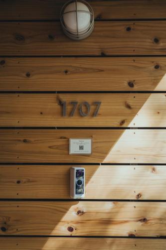 a sign on a wooden wall with a camera at SANU 2nd Home 八ヶ岳 3rd in Nagasawa