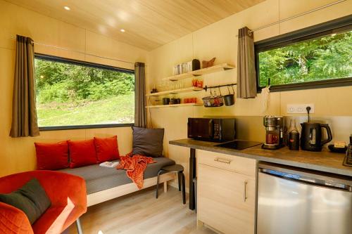 a small kitchen with a bench in a tiny house at FORET TOTEM - Hébergements nature et bien-être en pleine forêt in Persquen