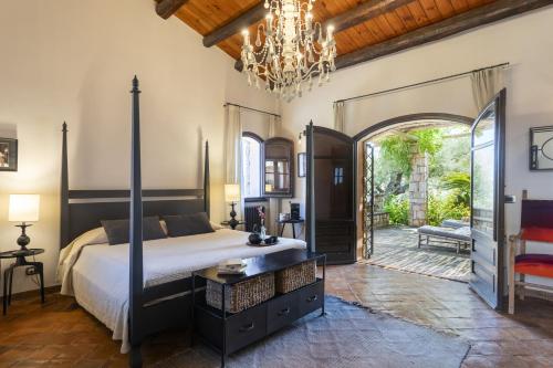 a bedroom with a bed and a chandelier at Villa Passulunara 14 by Massimo Villas in Collesano