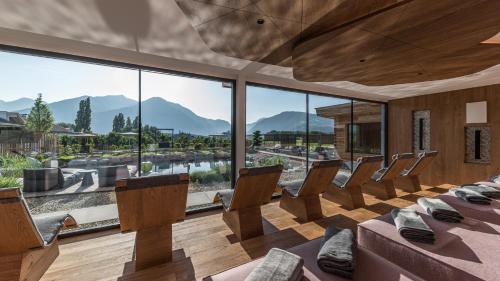 a room with chairs and a large window at Hotel Sun in Naz-Sciaves