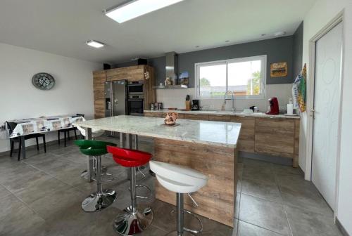 a kitchen with a large island with bar stools at Chez nicolas in Sendets