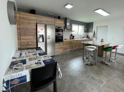 a kitchen with a island with a counter top at Chez nicolas in Sendets