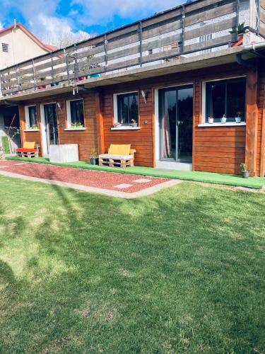 a house with a lawn in front of it at Studio Le Prunier in La Plaine des Cafres
