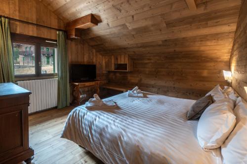 Ένα ή περισσότερα κρεβάτια σε δωμάτιο στο Hotel Chamois d'Or