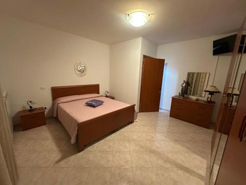 a bedroom with a bed and a light on the wall at B&B Dimora Saracena in San Giuliano di Puglia