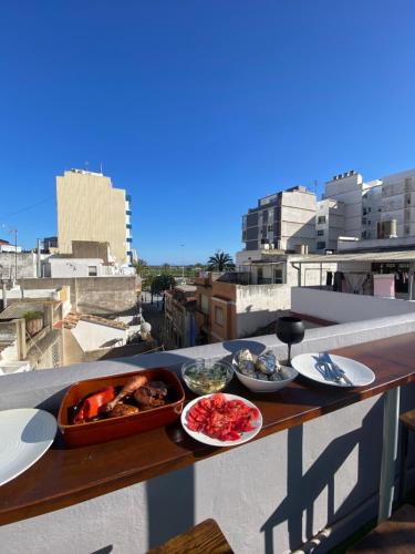 a tray of food on a table on a balcony at Oasis de Paz Cullera in Cullera