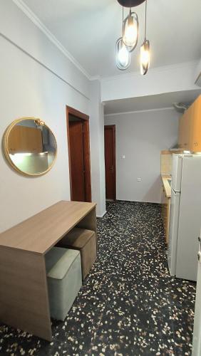 a kitchen with a table and a mirror on the wall at Villa Pavlina in Olympiada